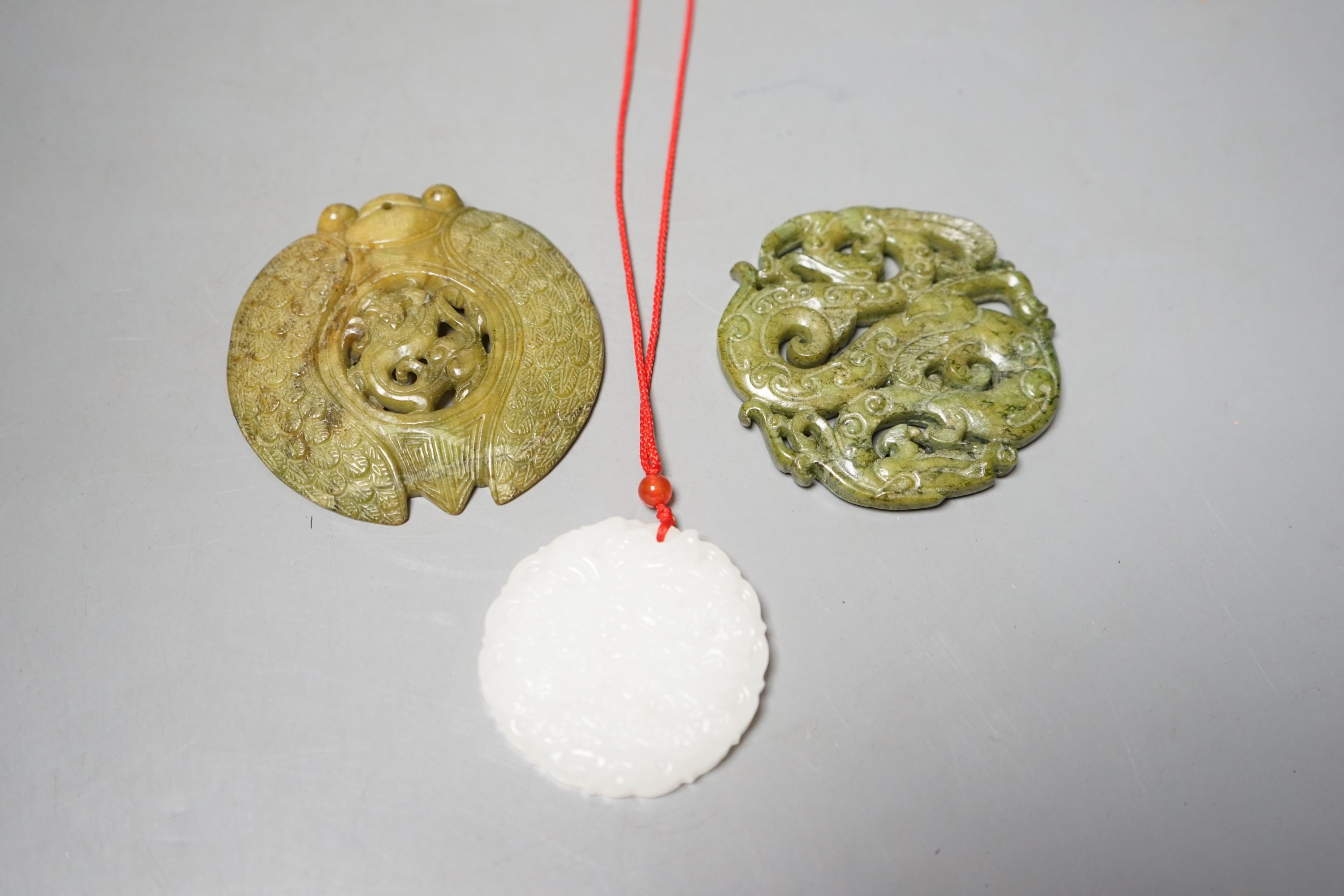 Three Chinese carved jade or hardstone pendants